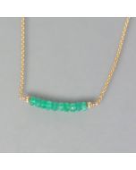 delicate necklace of gold with emerald