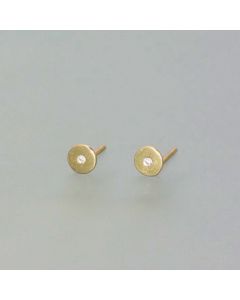 Delicate gold stud earrings with a small diamond