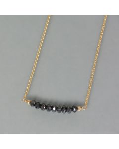 delicate necklace of gold with black diamonds